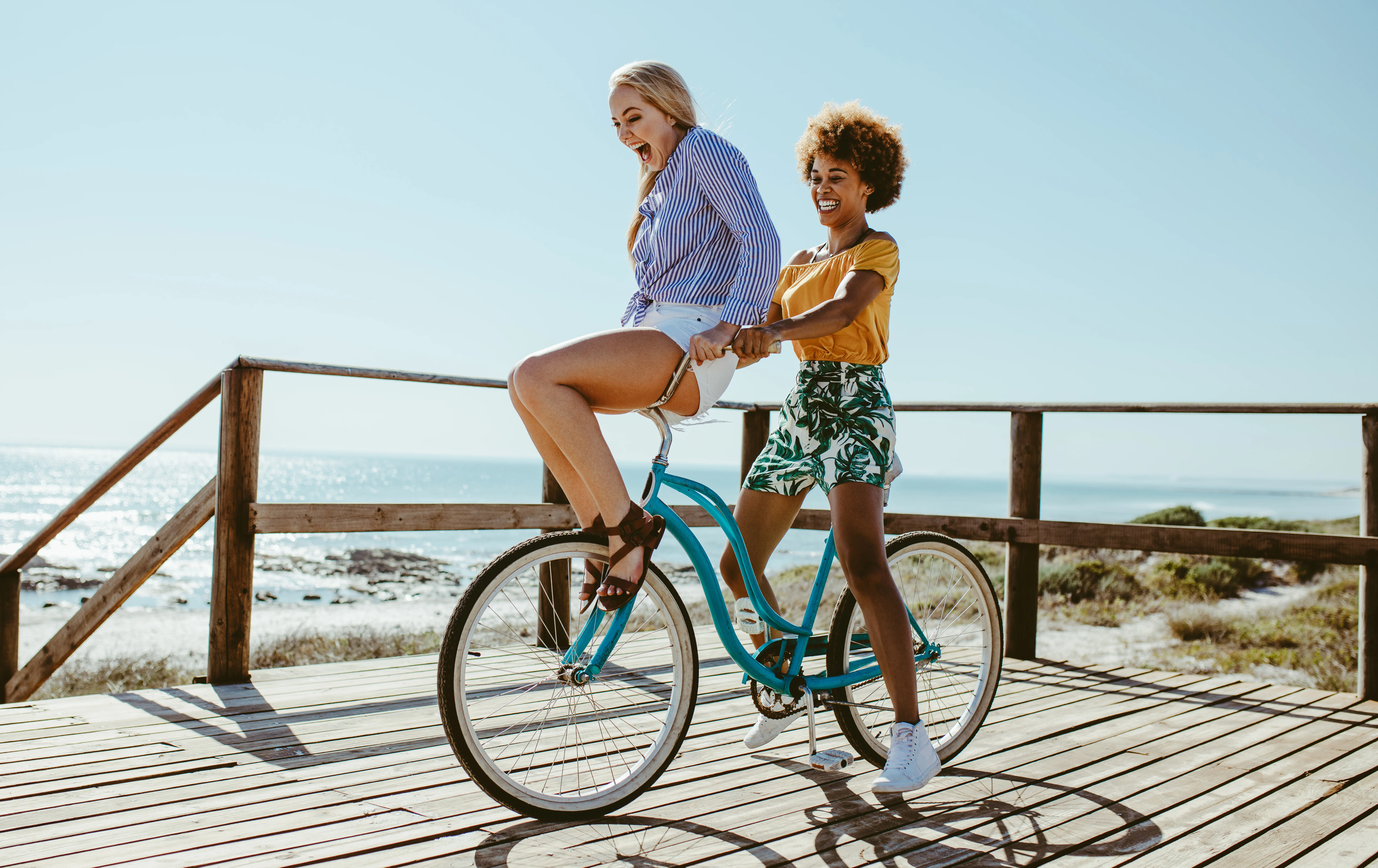 Two women riding one bicycle