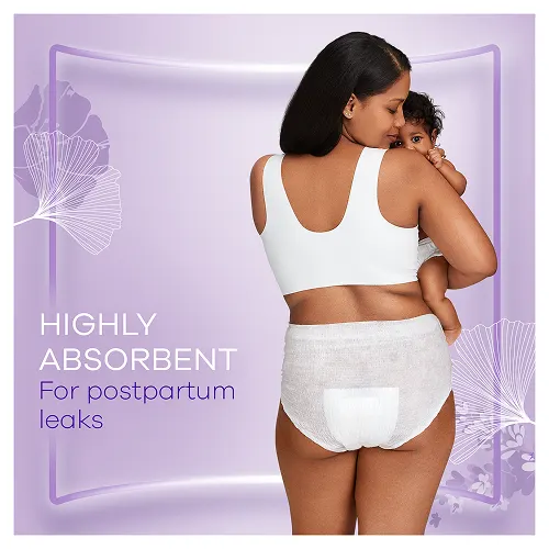 Mum wearing postpartum pants playing with her infant