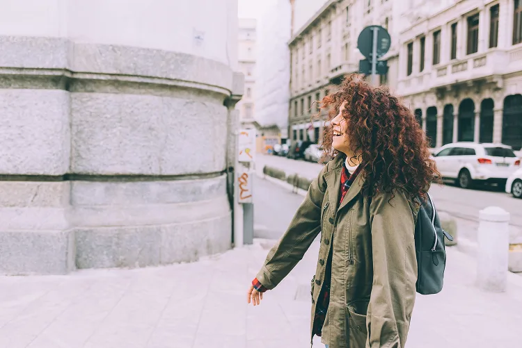 Girl smiling while walking down the street