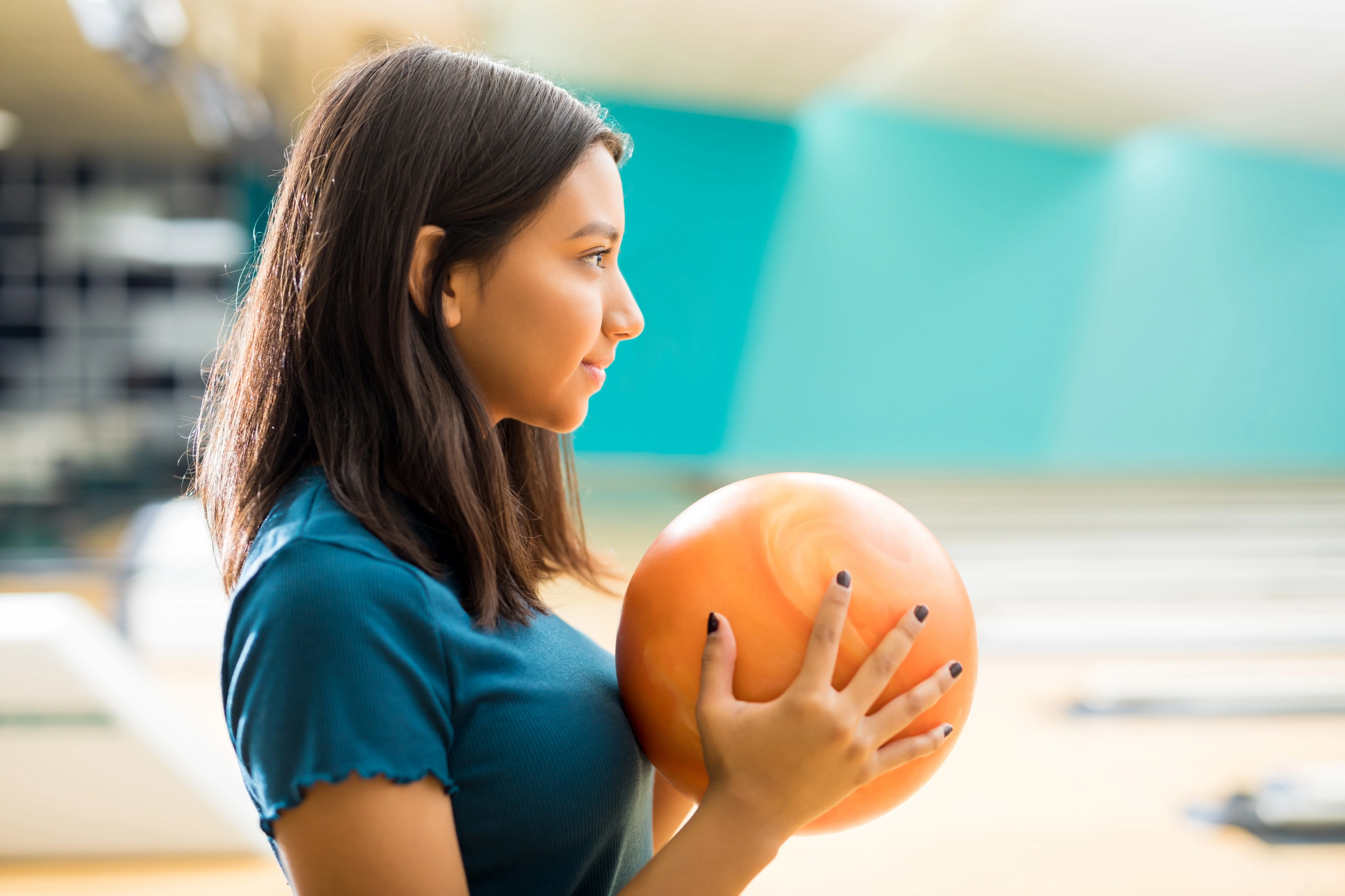 Girl in a gym with the ball in hands