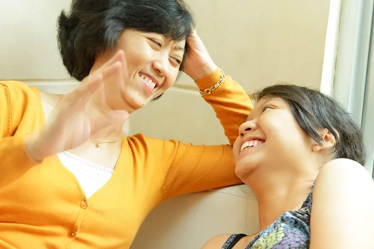 Mother and daughter laughing