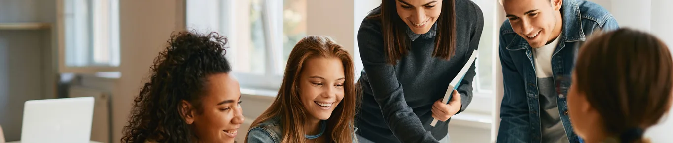 Two girls sitting on a bench and taking notes in a notebook