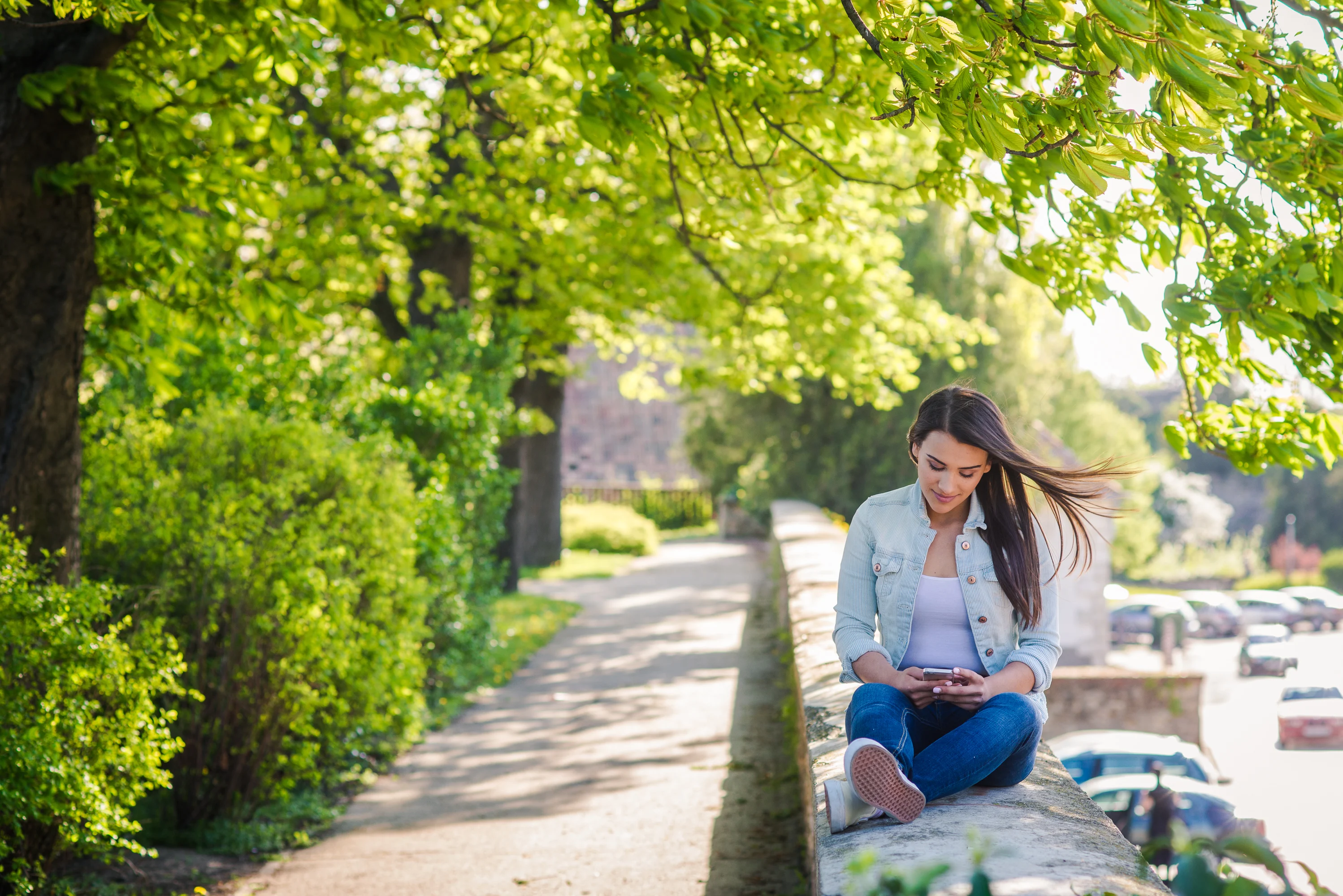 Girl sitting in nature pathway