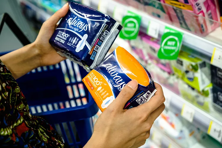 Woman's hands holding Always sanitary pads packaging