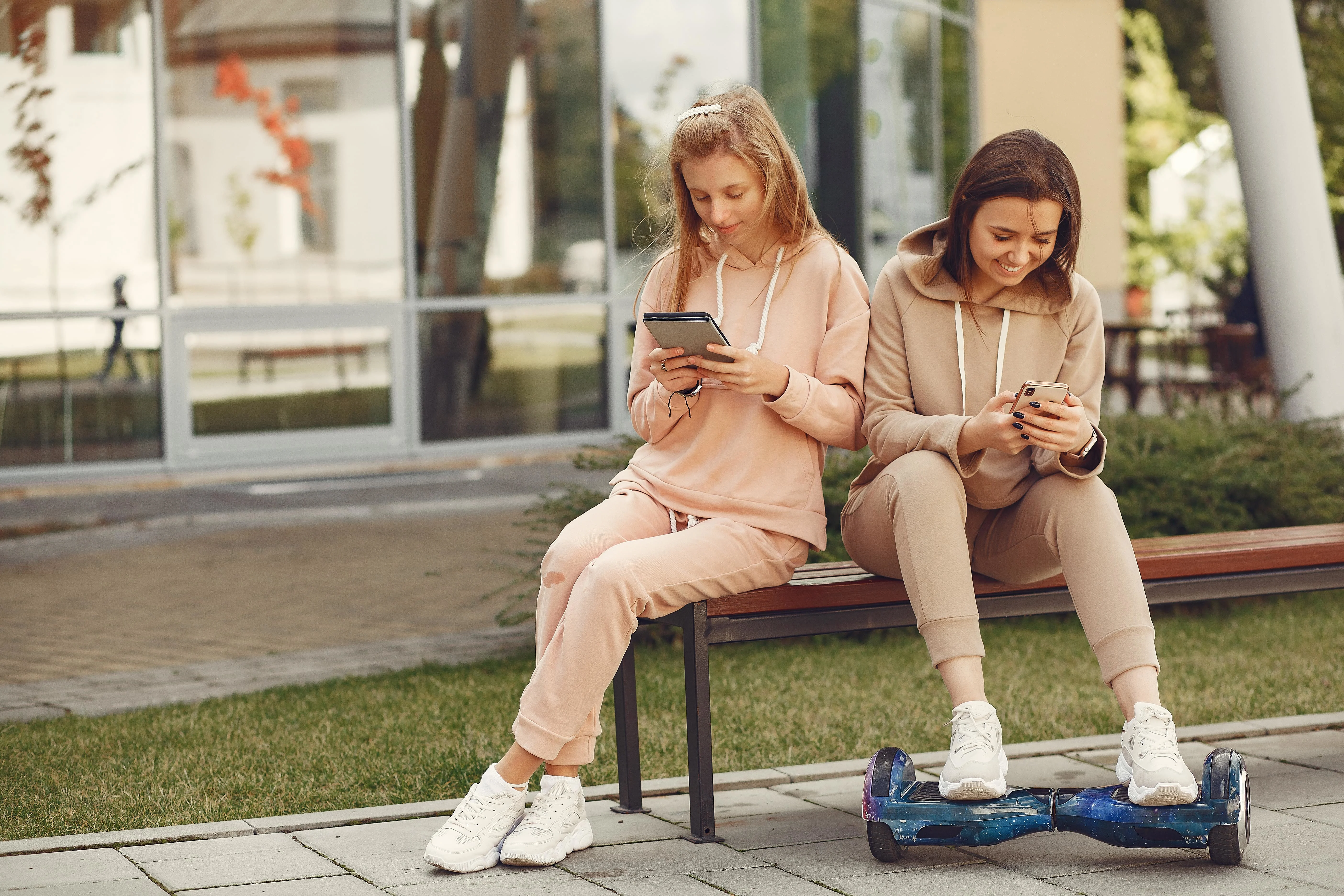 Two girls scrolling on their phones