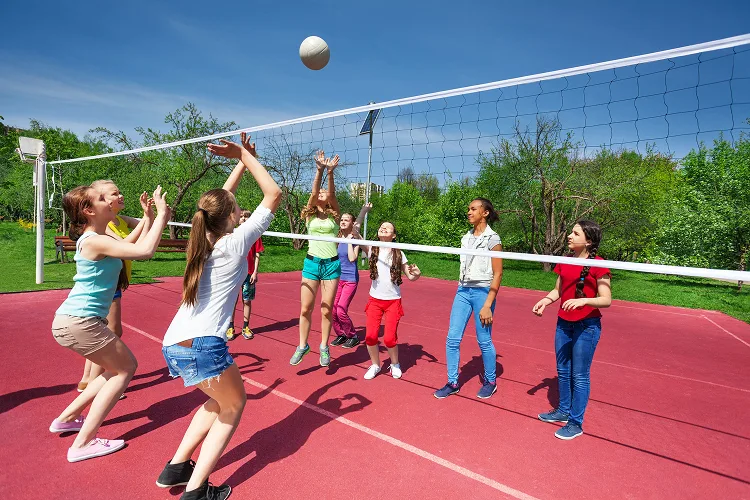 Girls playing volleyball outside