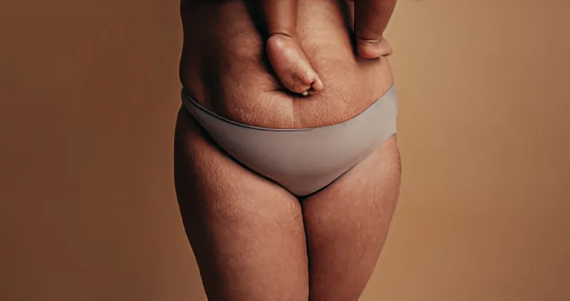 Belly of a woman holding a baby in her arms