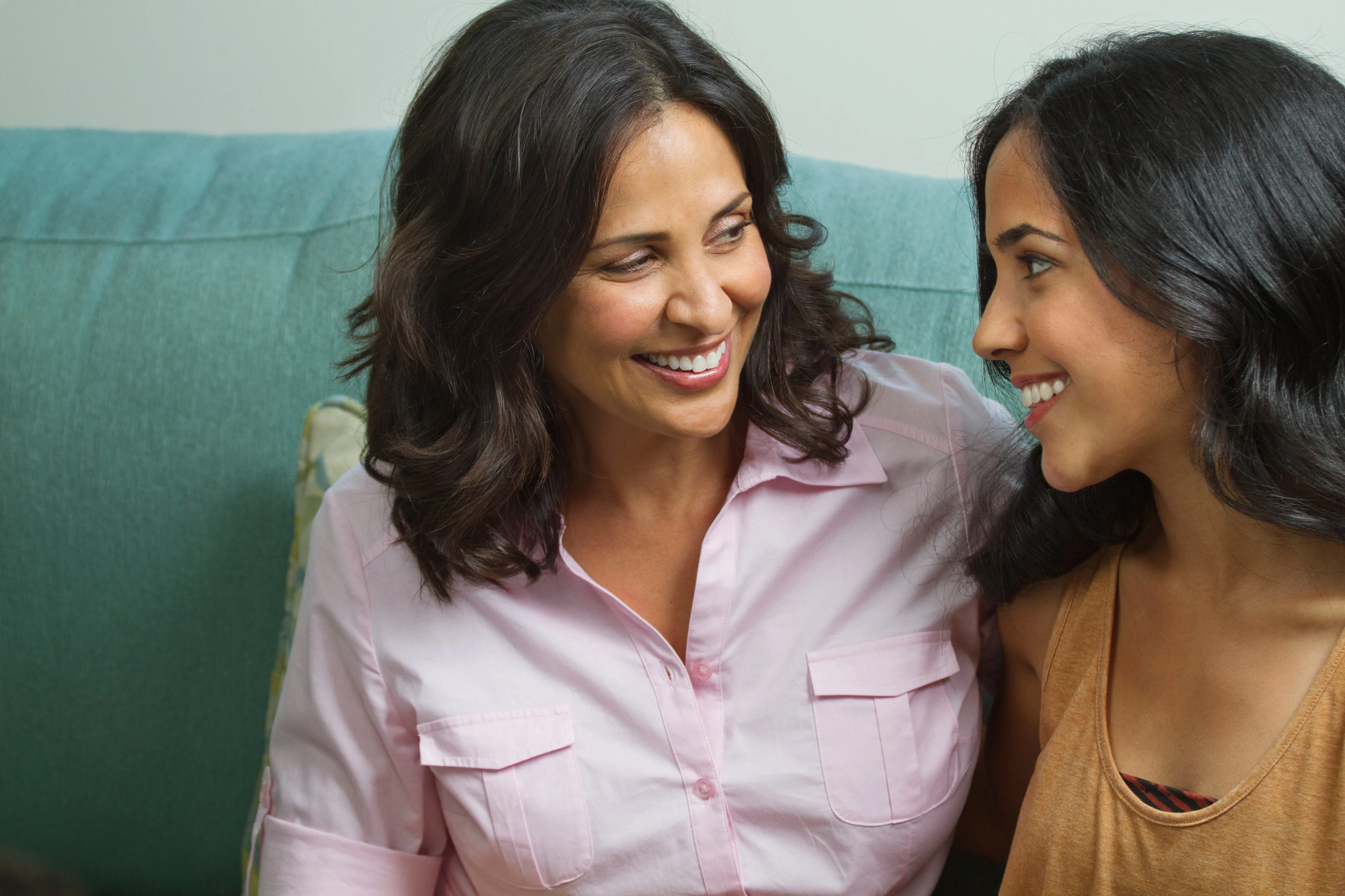 Portrait of a mother and a daughter smiling at each other