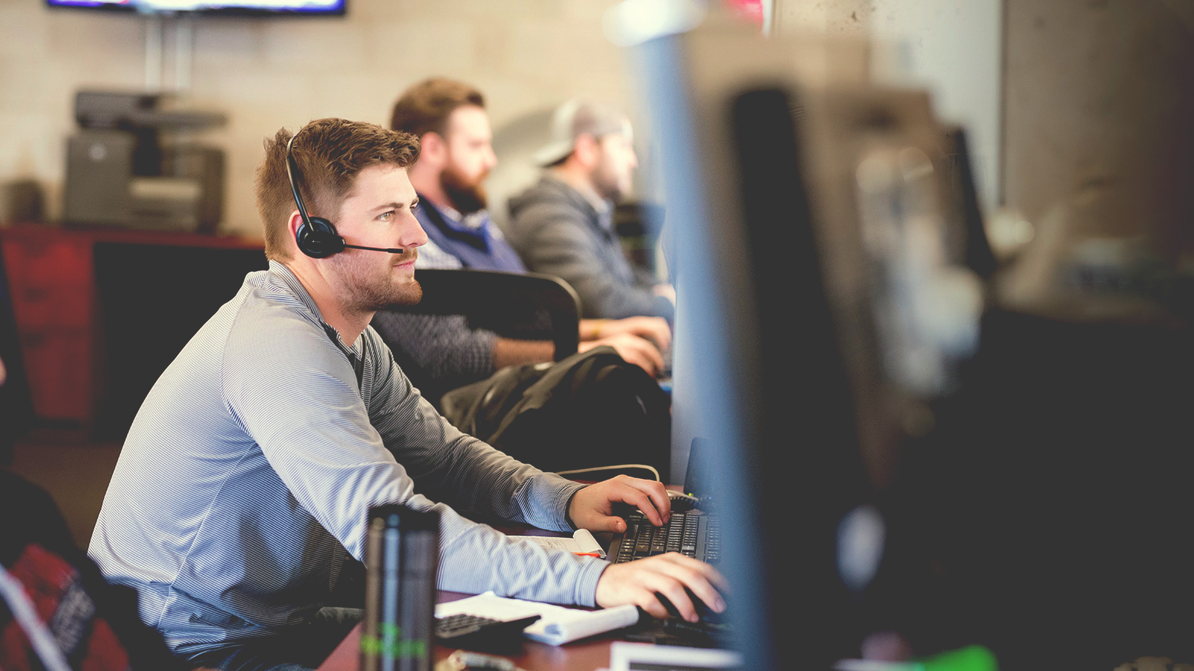 Man seated at a desk working on a computer.