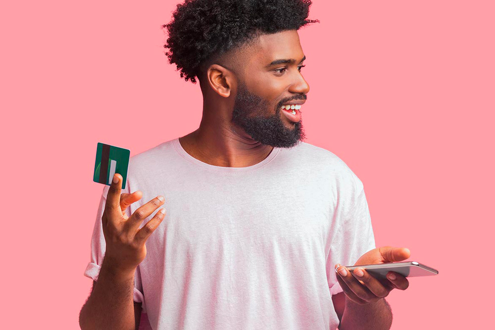 Man holding mobile phone and credit card.