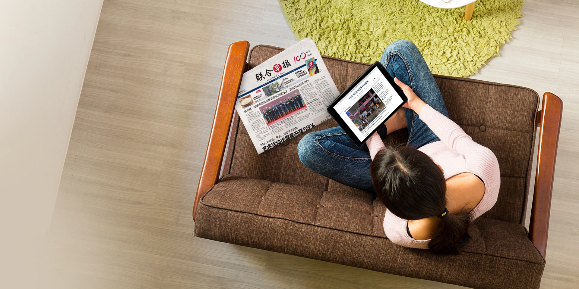 Woman reading news on her tablet device.