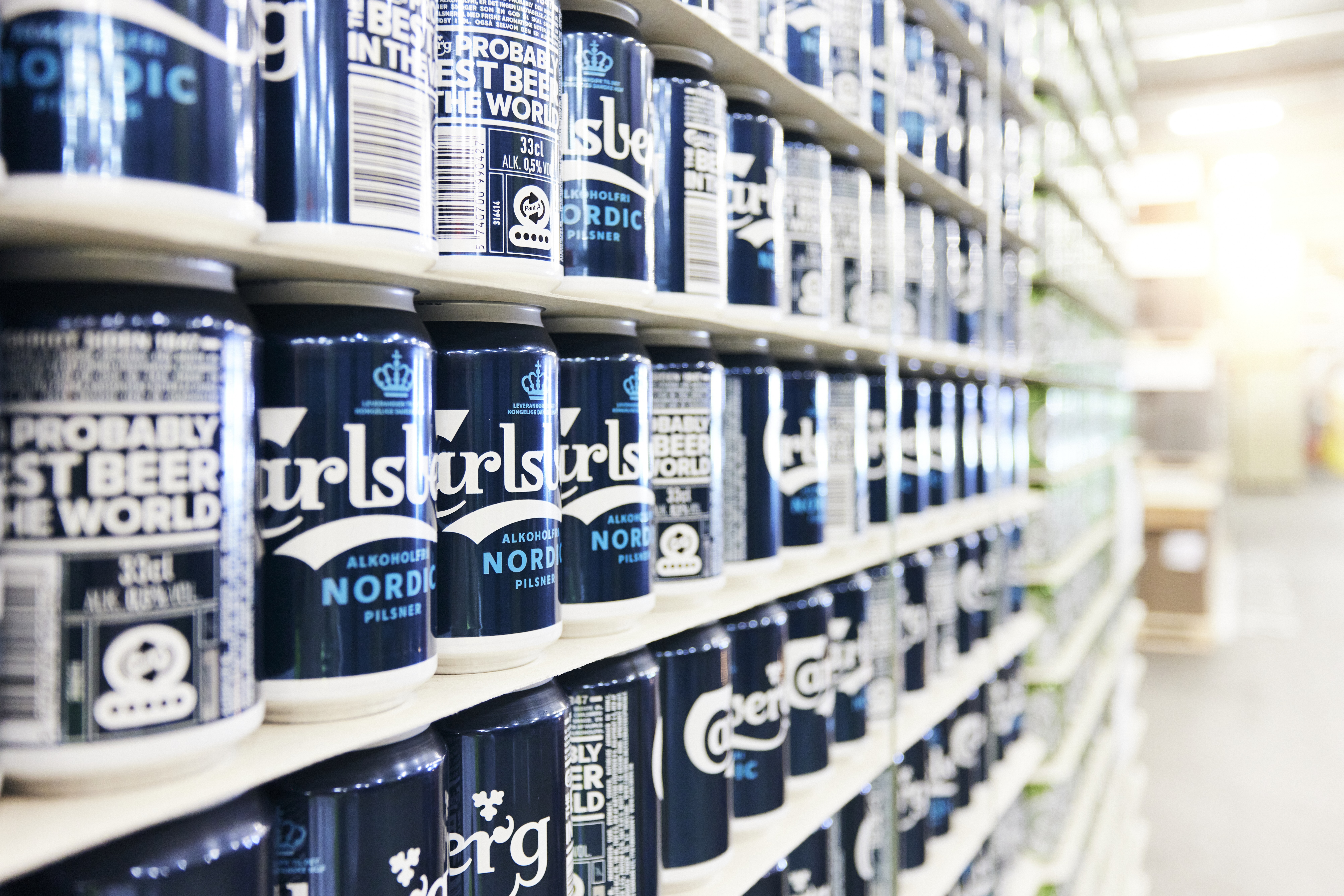 Cans of Carlsberg beer on a shelf 