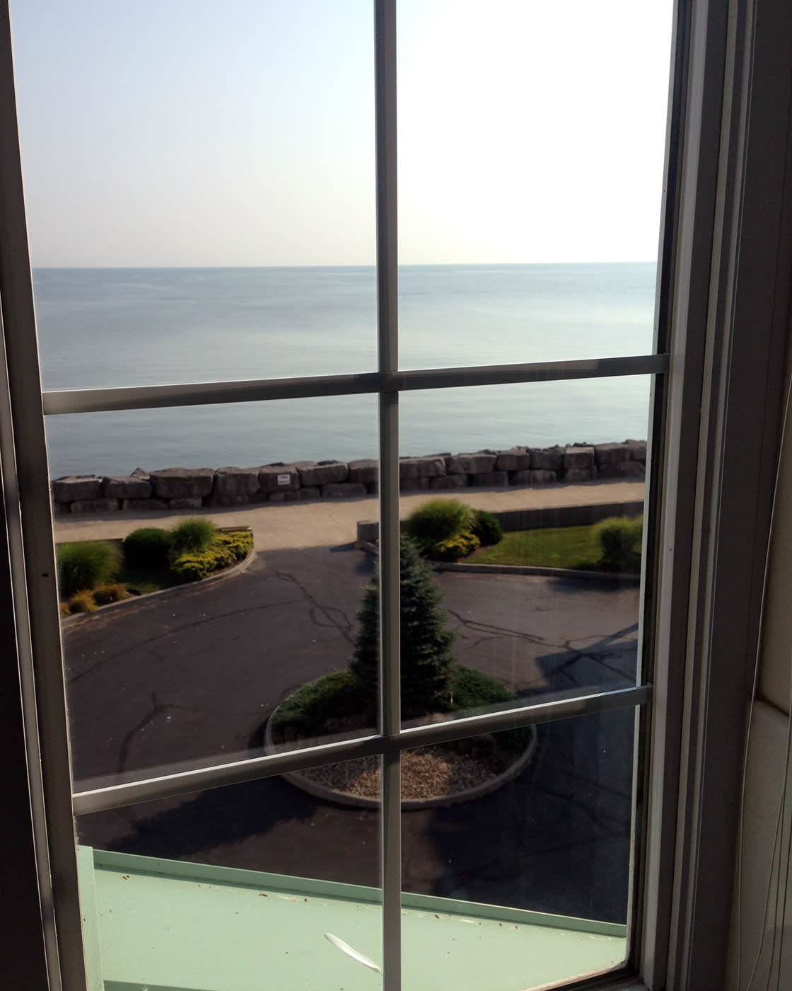 A window close up looking out to the lake in the background