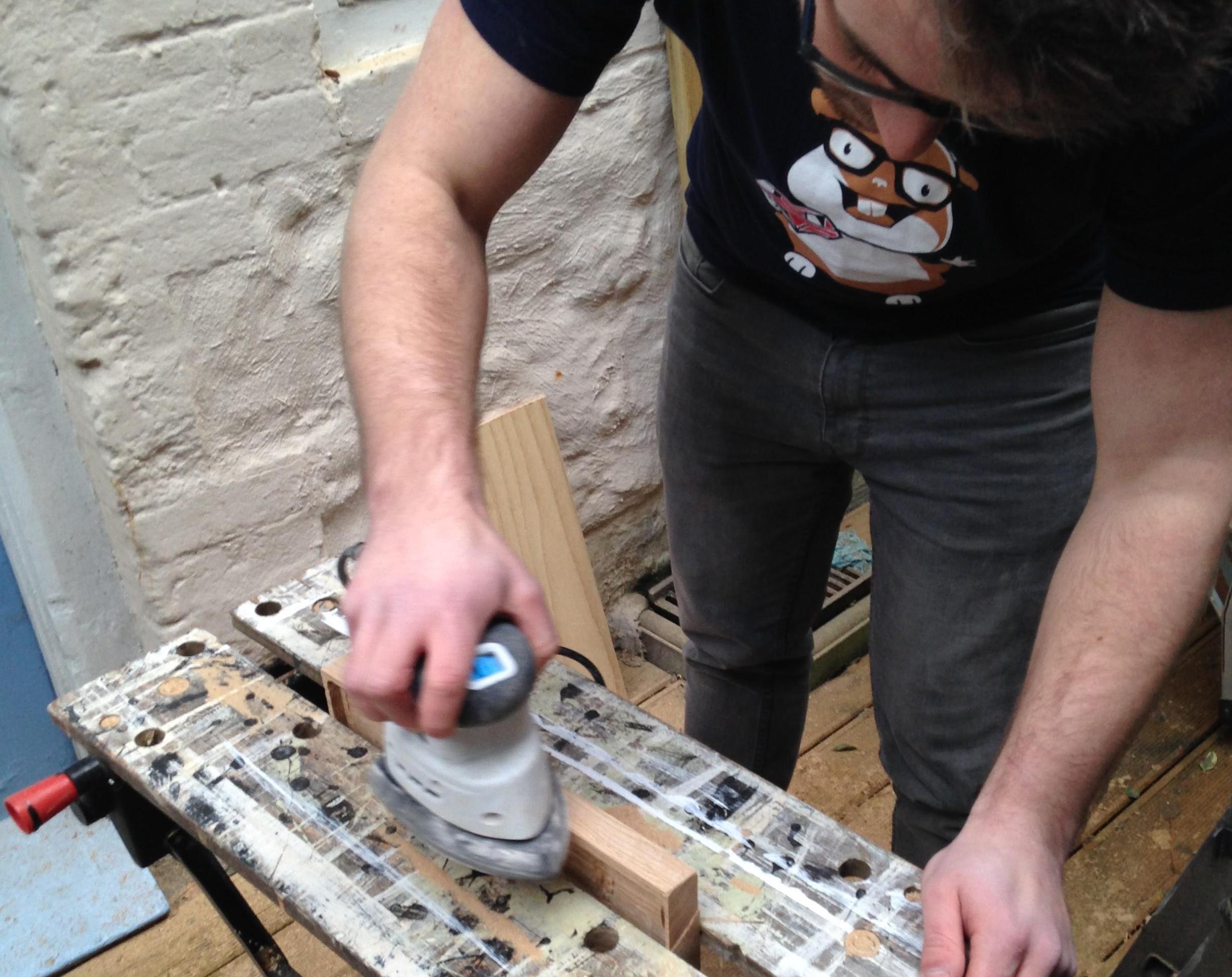 building-a-custom-keyboard-case Smoothing out the wood with a sander