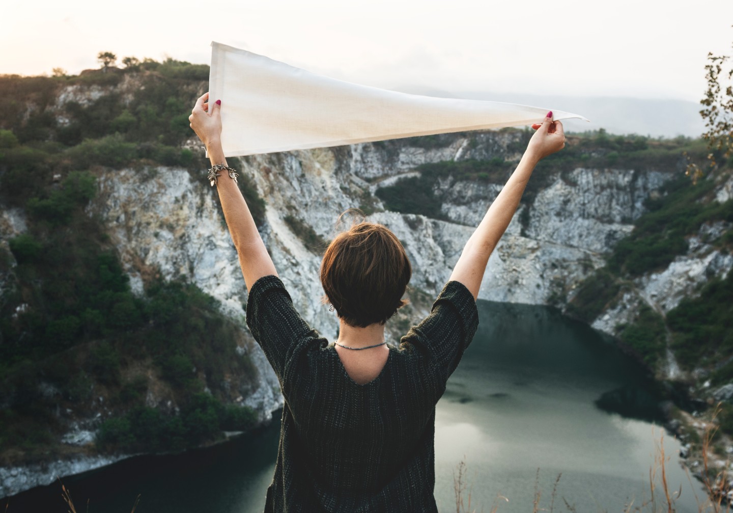 woman-in-nature-holding-white-flag