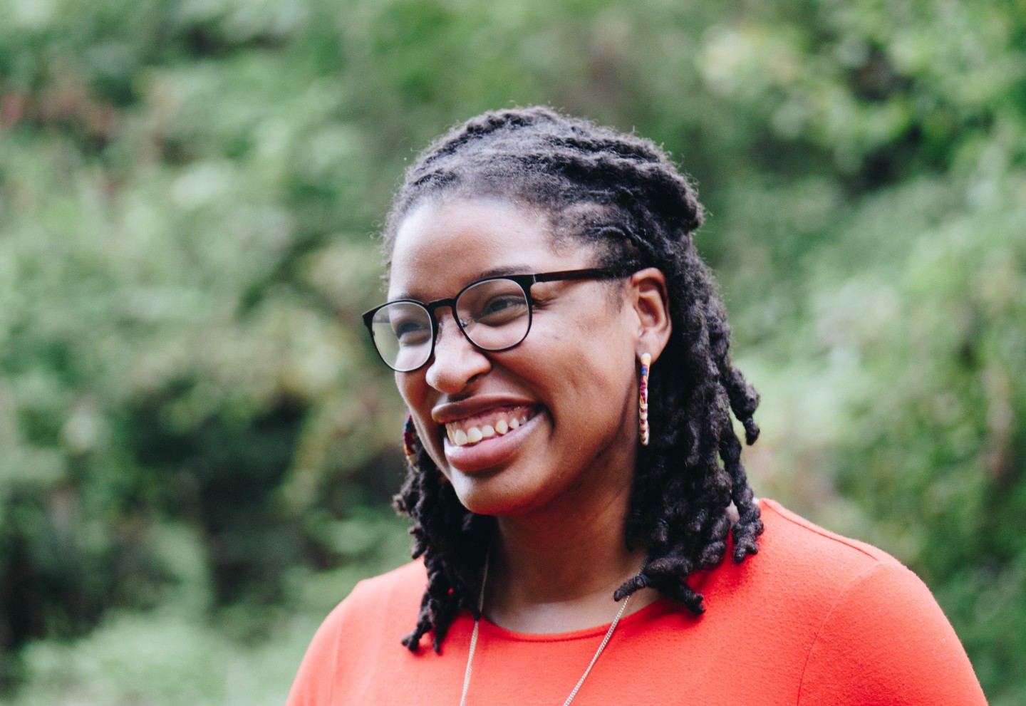 smiling-woman-in-orange-shirt