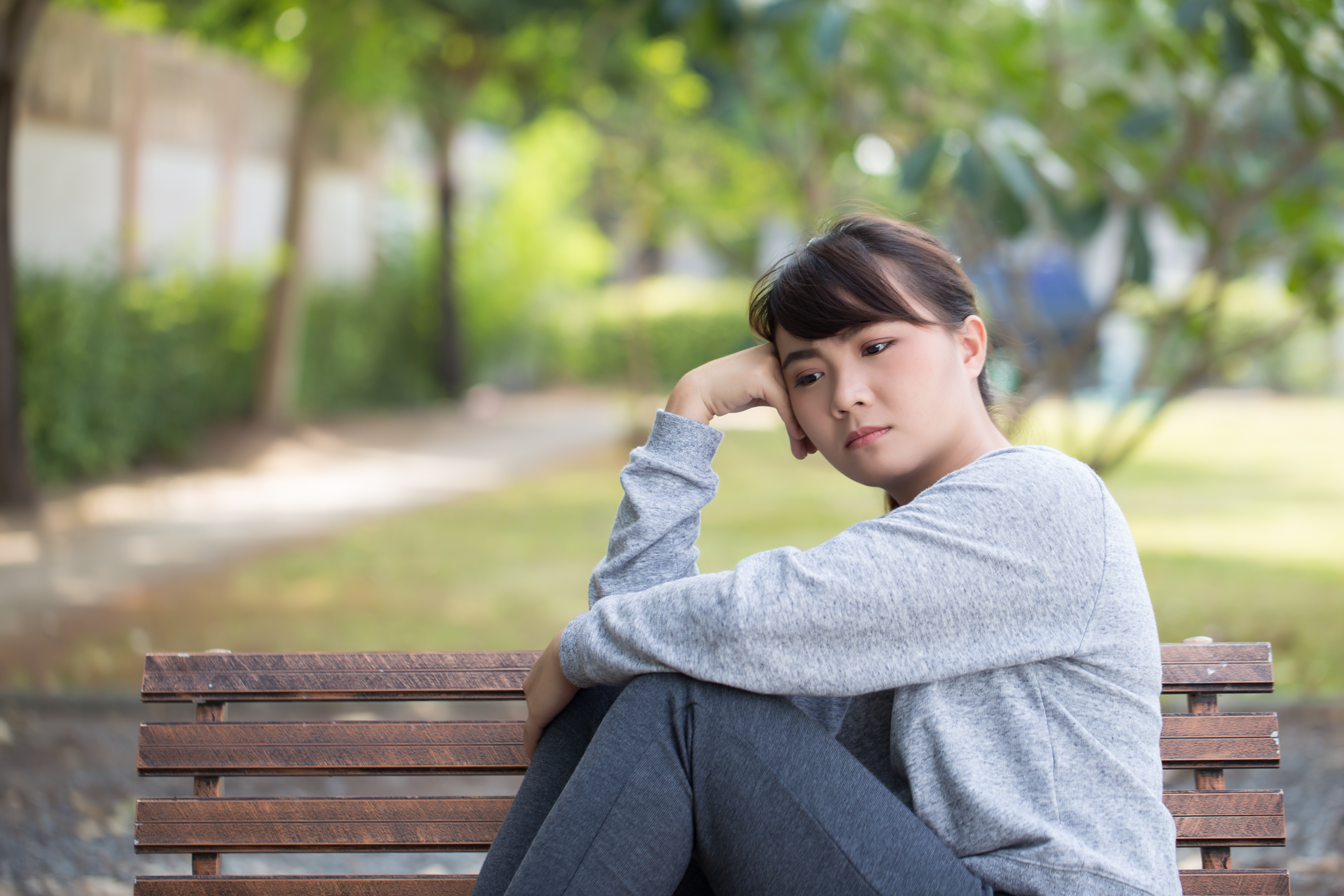 Sad Woman Sitting On Bench Image