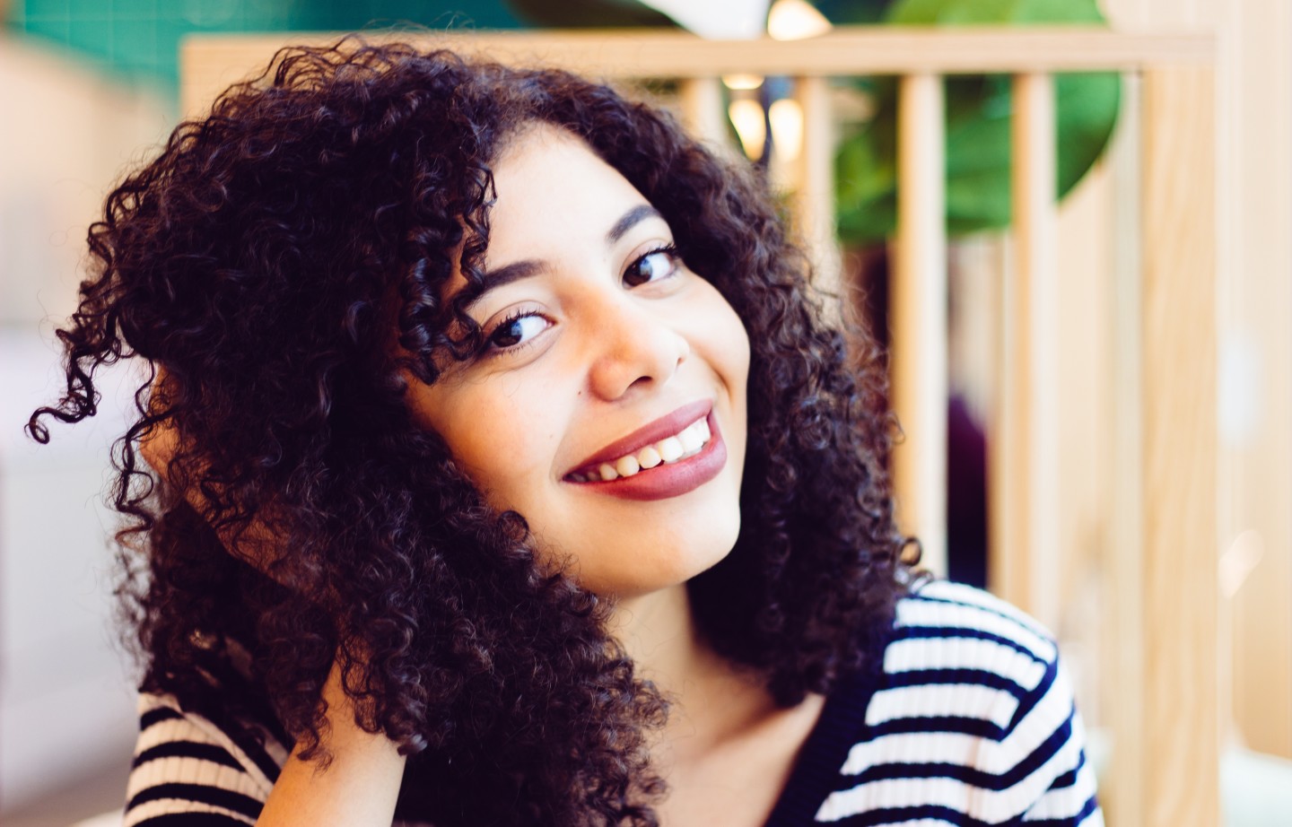 woman-with-curly-hair-smiling