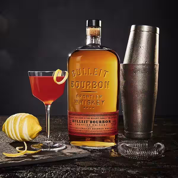 A glass of Bulleit Whiskey Paper Plane. Click to find our recipe for Whiskey Paper Plane