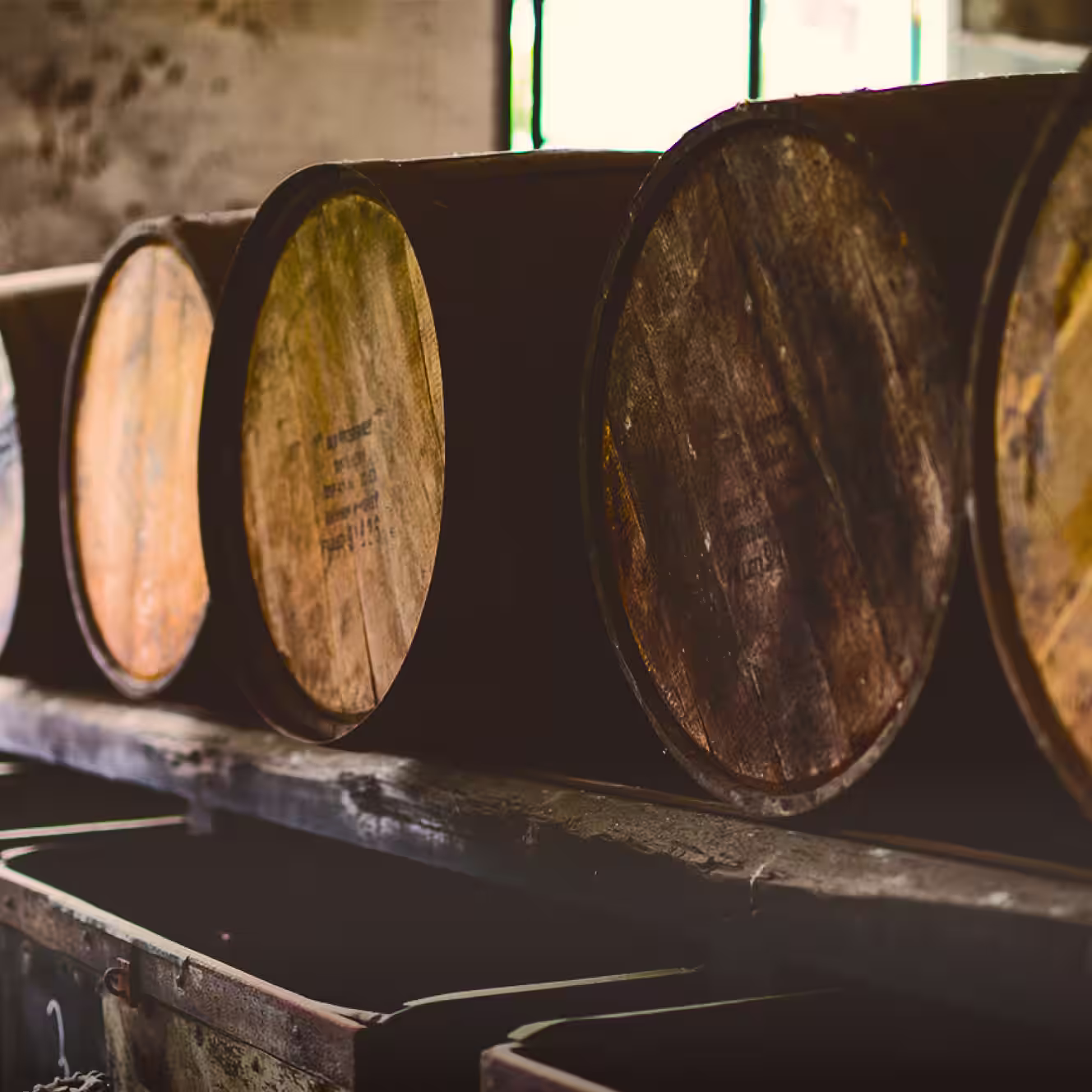 Whiskey barrels aging on racks inside the Bulleit distillery