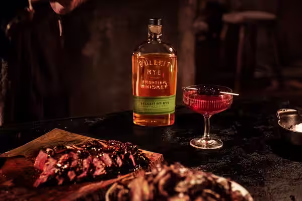 A glass of Bulleit Bourbon with tonic and ice.