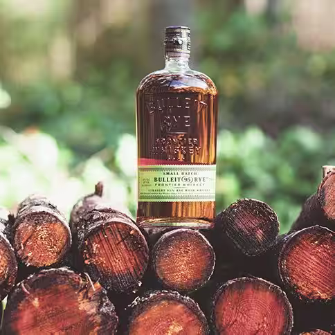 A bottle of Bulleit Rye on chopped wood