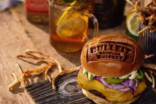 A glass of Bulleit Bourbon with tonic and ice.