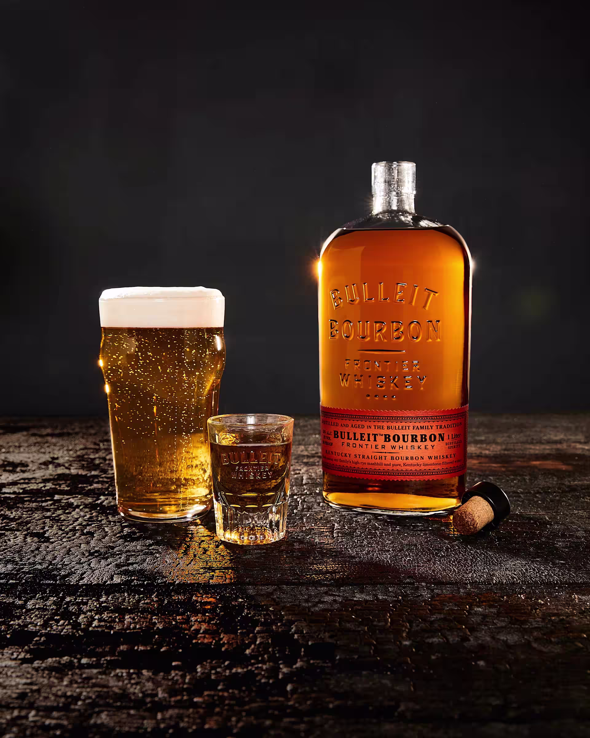 Bulleit Boilermaker with a pint of beer, whiskey shot and Bulleit Bourbon bottle