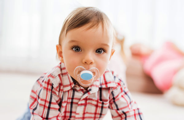 Using pacifiers for the first year or two isn’t harmful. In fact, many hospitals are recommending to new mothers to use a pacifier during bedtime because it may slightly decrease the risk for Sudden Infant Death Syndrome (SIDS) in addition to soothing your baby and helping to develop important muscles around the mouth. 