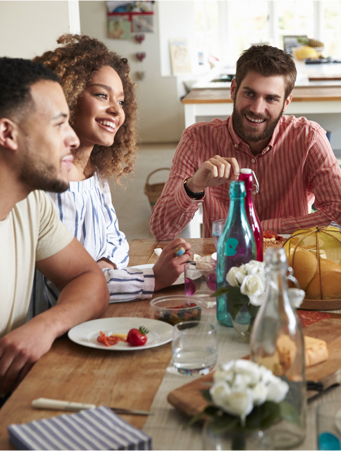 Group of friends sitting around a kitchen table