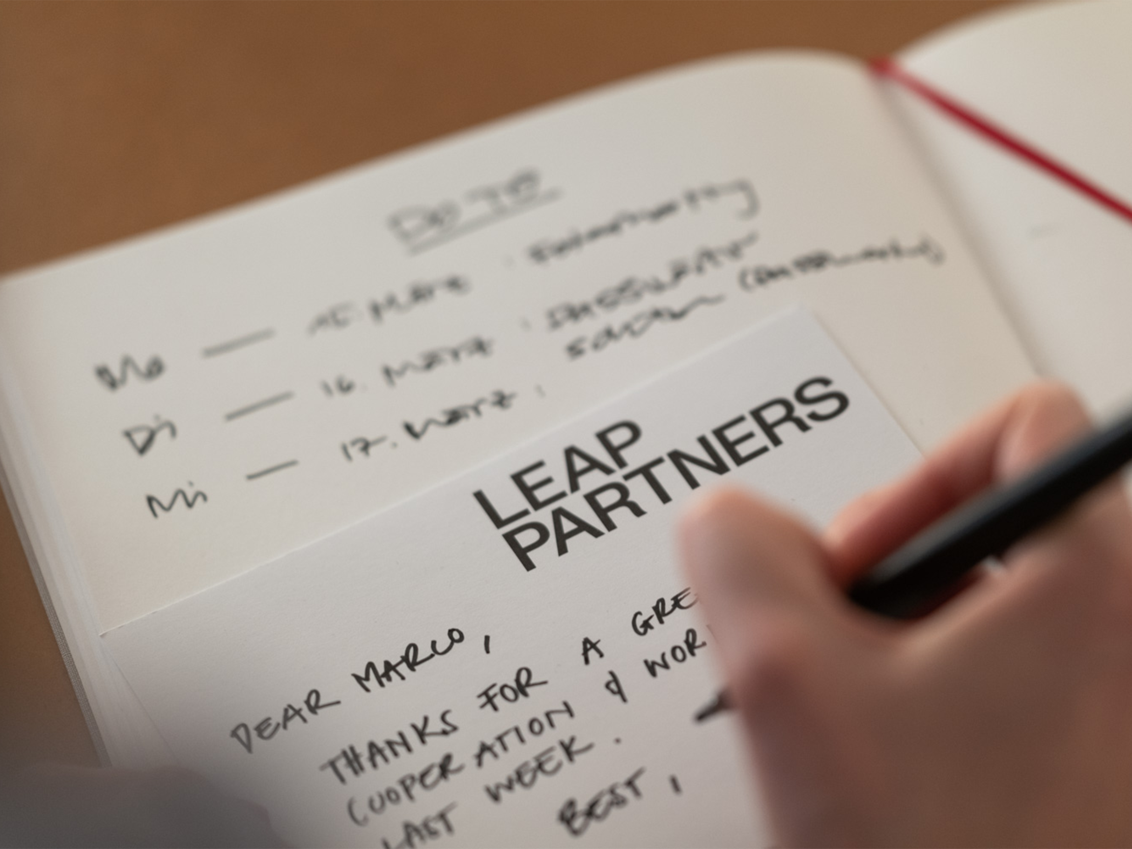 Image of a hand writing a to-do list for LEAP PARTNERS.