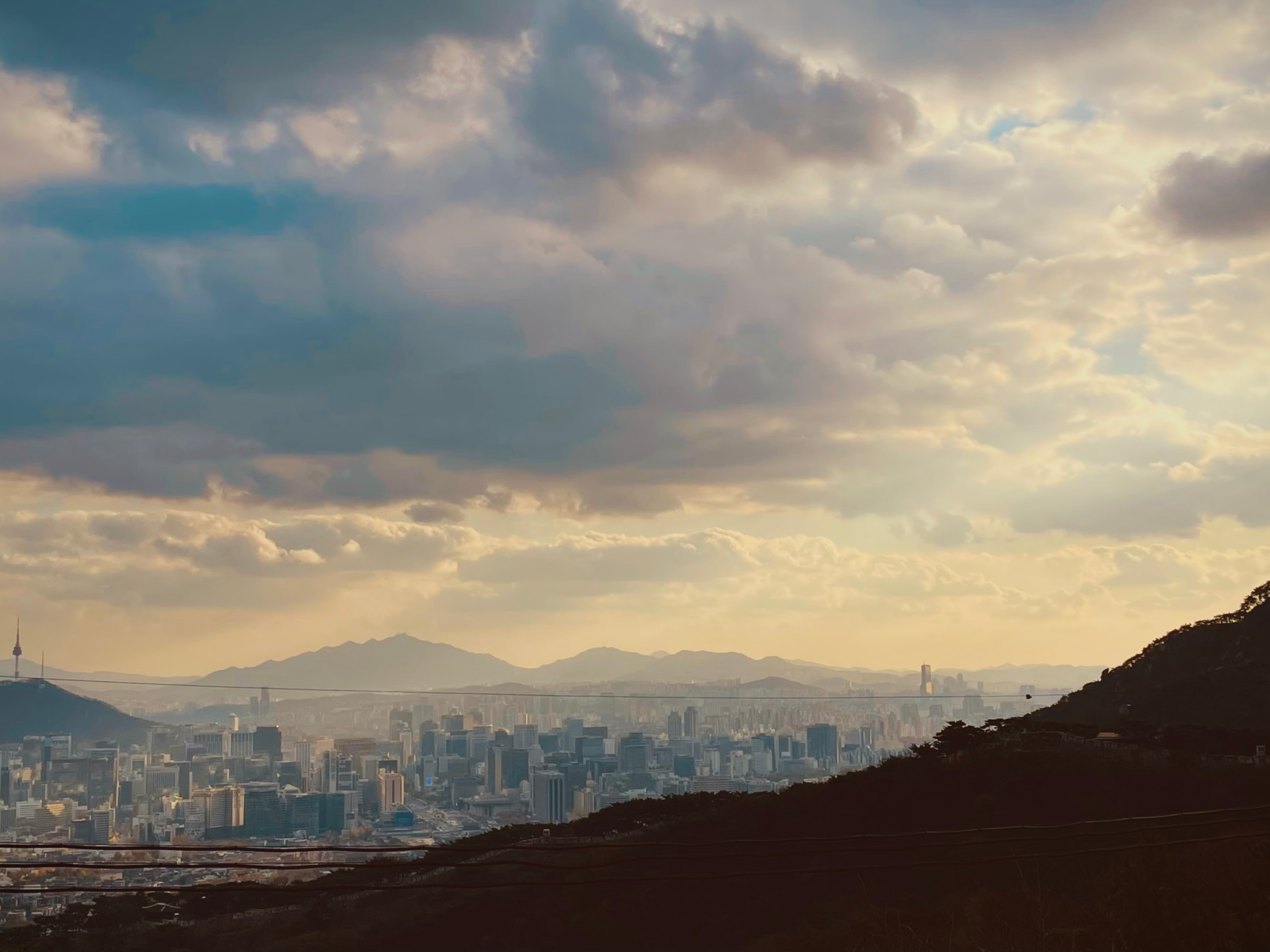 Image at dusk from the perspective of a hill overlooking Seoul.