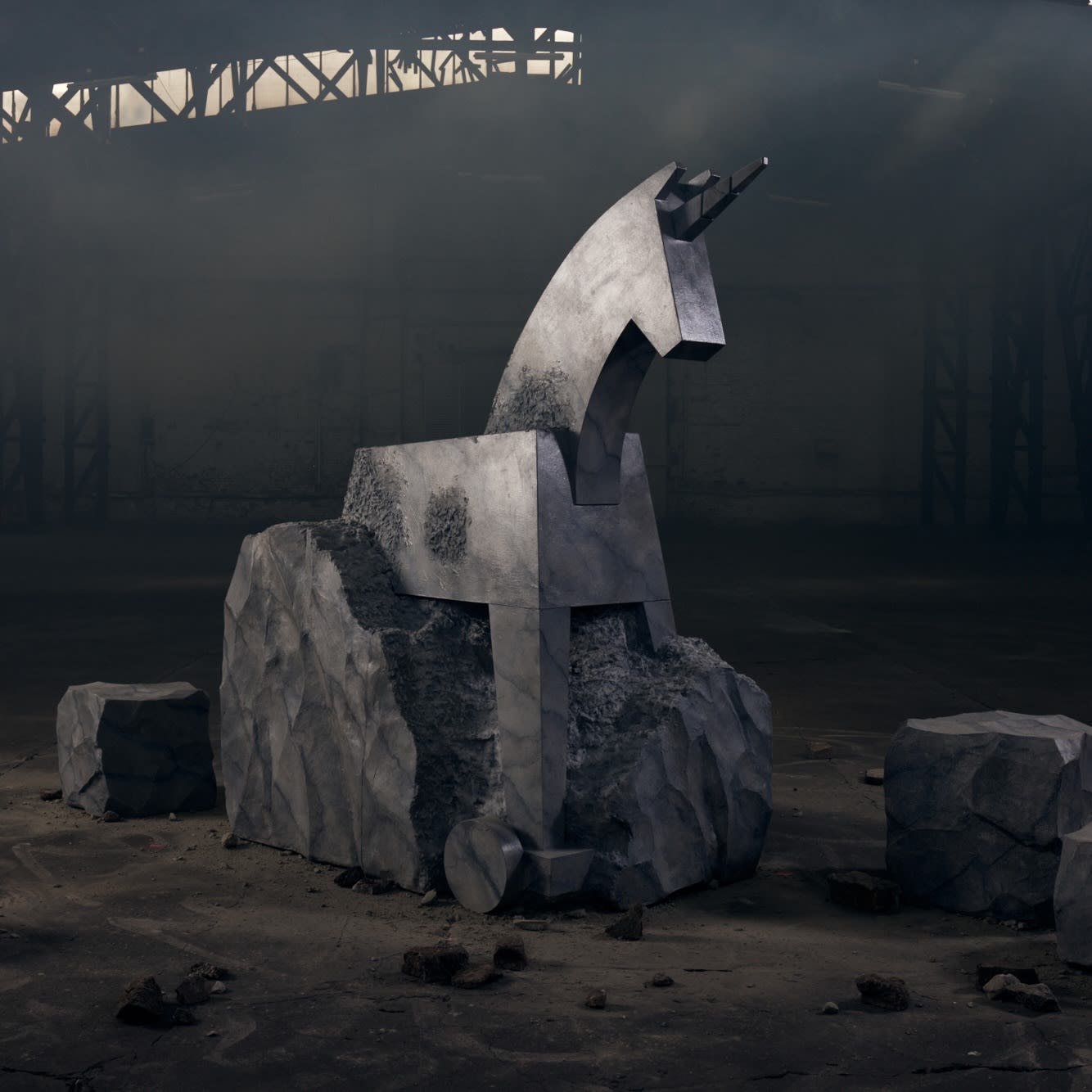 Image showing a sculpture of a Trojan horse, Jung von Matt's brand logo, emerging from a stone-like rock in the middle of a dark room.