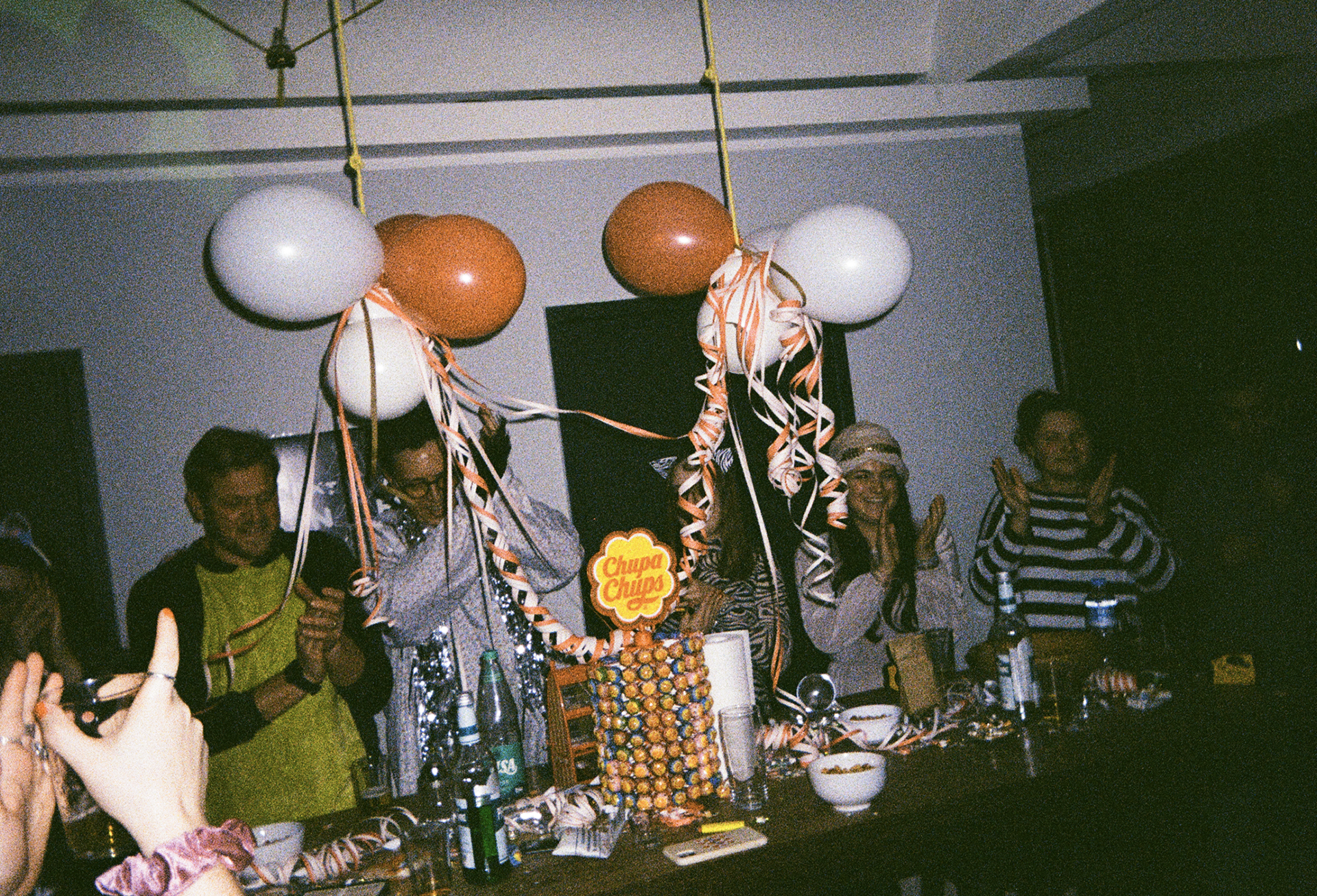 Employees of Jung von matt Hamburg having a party with baloons and decoration hanging from the ceiling