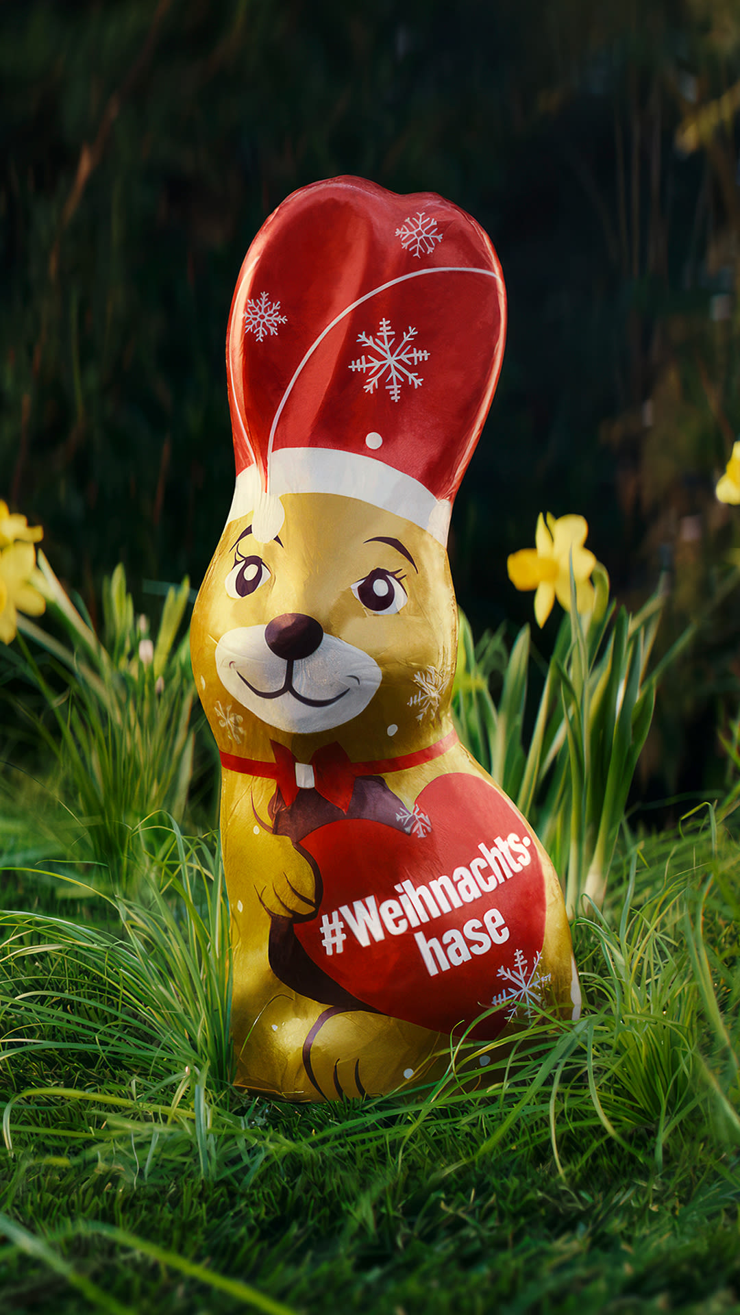 Jung von Matt HAMBURG’s christmas campaign TVC for for retailer chain EDEKA thematising alzheimer's disease: a chocolate easter bunny dressed as santa claus standing in green grass with with daffodils in the background