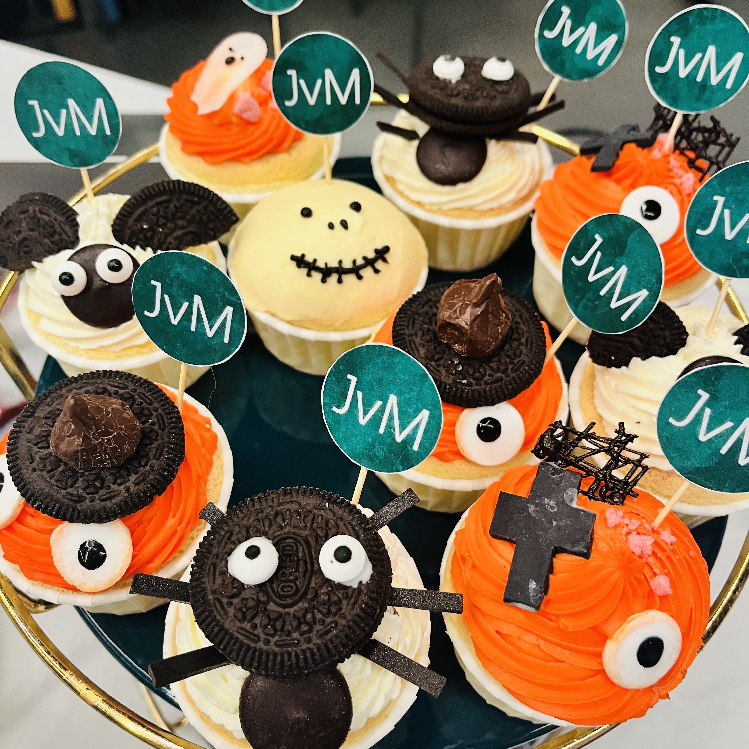 Image of a plate of OREO cupcakes in the shape of Halloween characters. Small Jung of Matt logo flags are stuck inside the cupcakes.