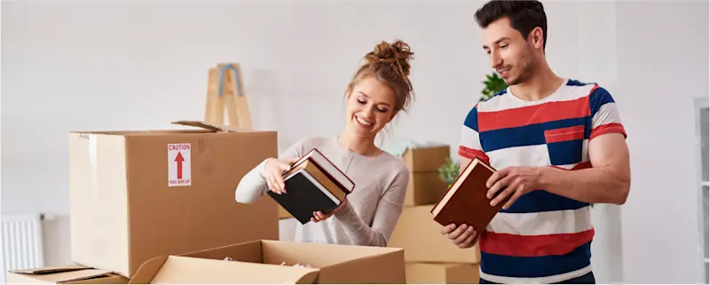 A couple packing books safely in boxes for a move