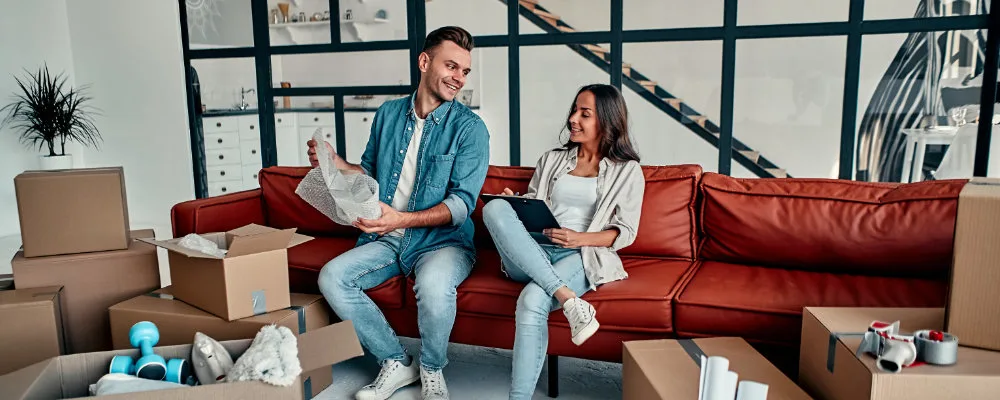 Couple packing moving boxes