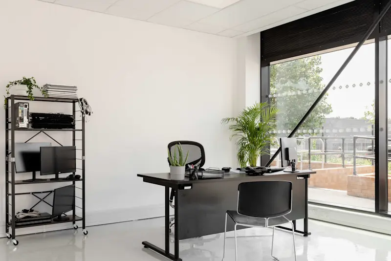 Office with a desk, shelf and big window