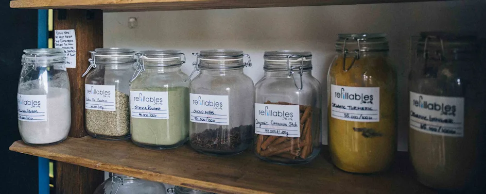 Reusable jars used for different spices in a pantry Edit