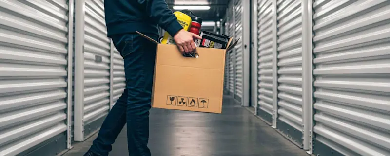 A person loading boxes into a STOREX storage unit
