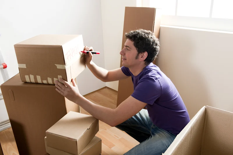man writing on box