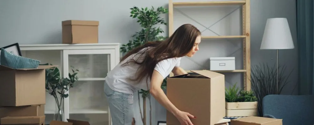 A woman stacking her boxes ready to move