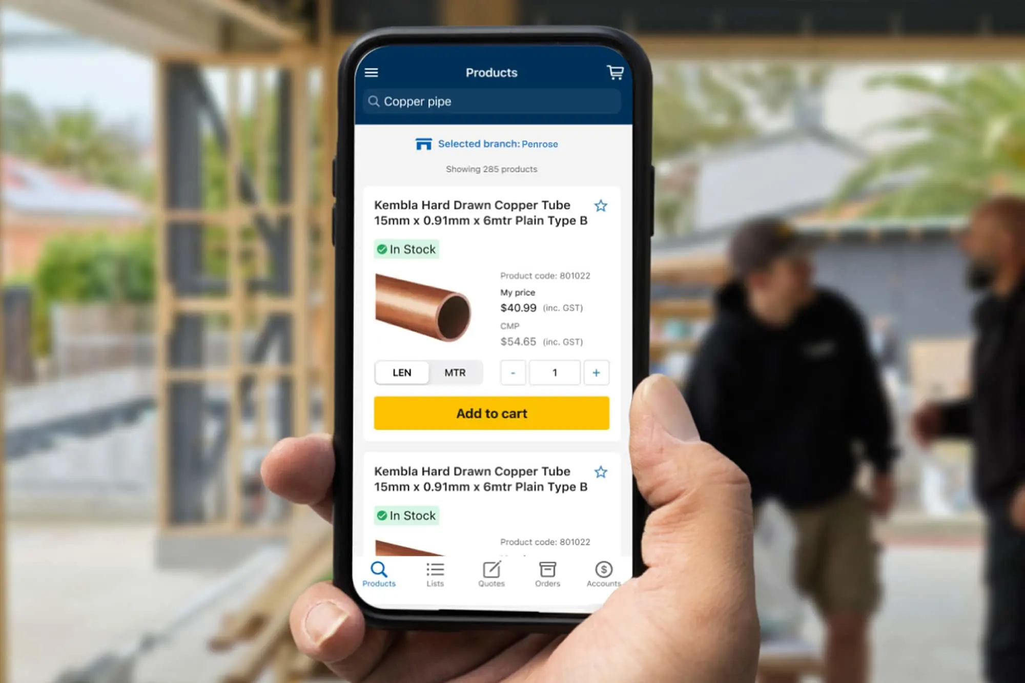 Hand holding smartphone displaying product listing for copper pipe with pricing and add to cart button.