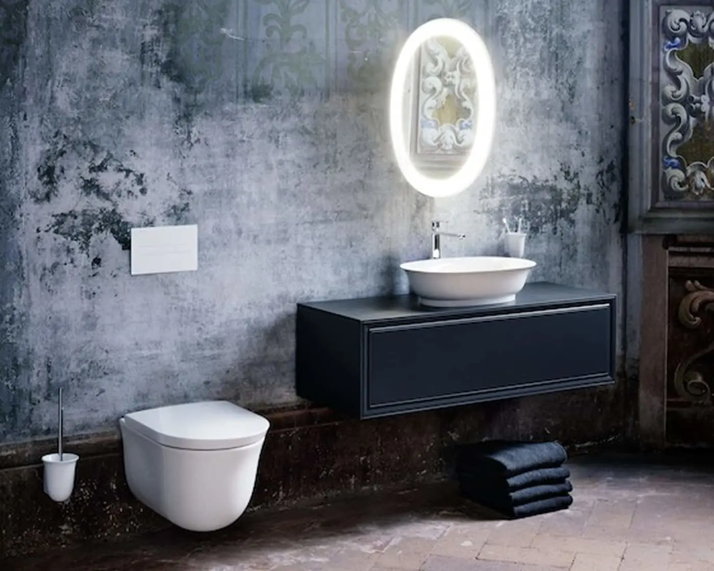 Bathroom with white toilet, black floating vanity, vessel sink, and illuminated oval mirror on textured gray wall.
