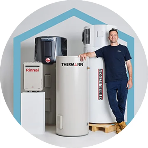 Man standing next to three water heater units: Rinnai, Thermann, and Stiebel Eltron models in a room with blue trim.