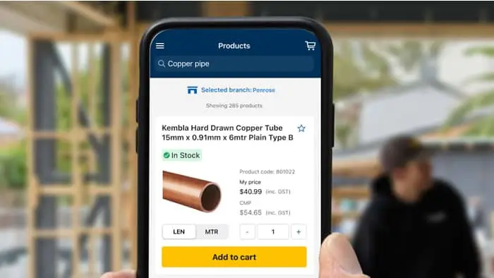Smartphone displaying a product page for copper pipe with image, pricing, quantity selector, and yellow add to cart button.
