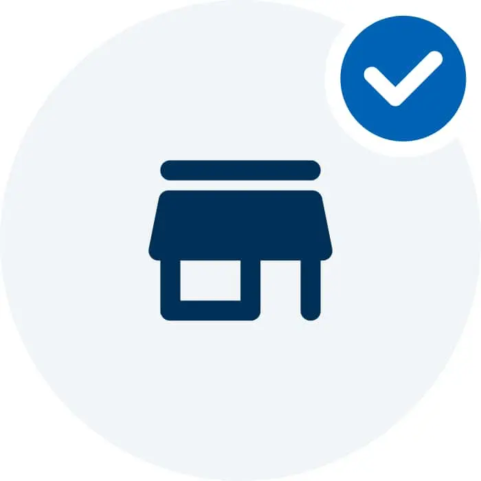 Dark blue storefront icon with a blue checkmark in a circle on a light gray background