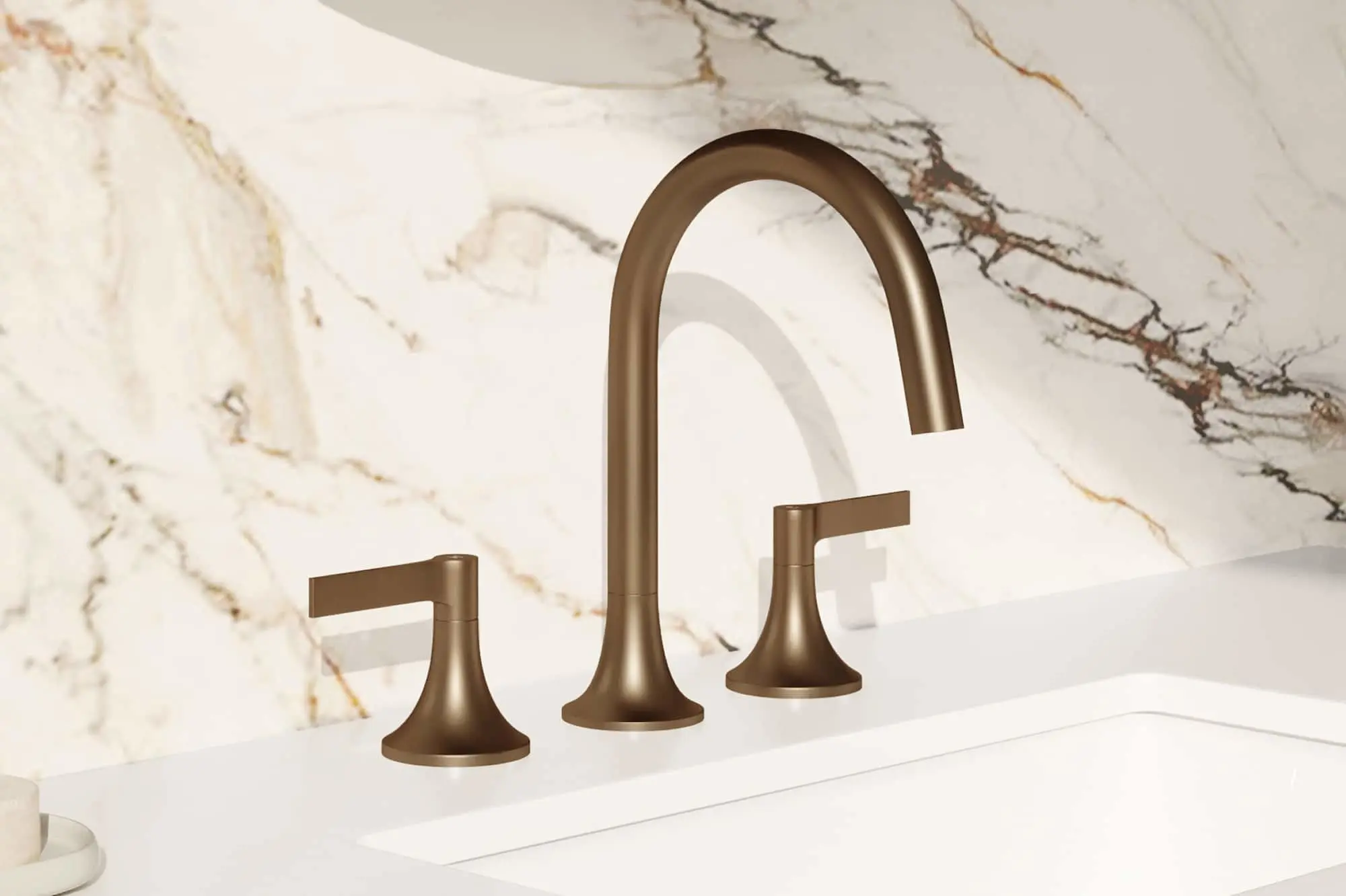 Bronze three-piece bathroom faucet on white sink with marble backsplash