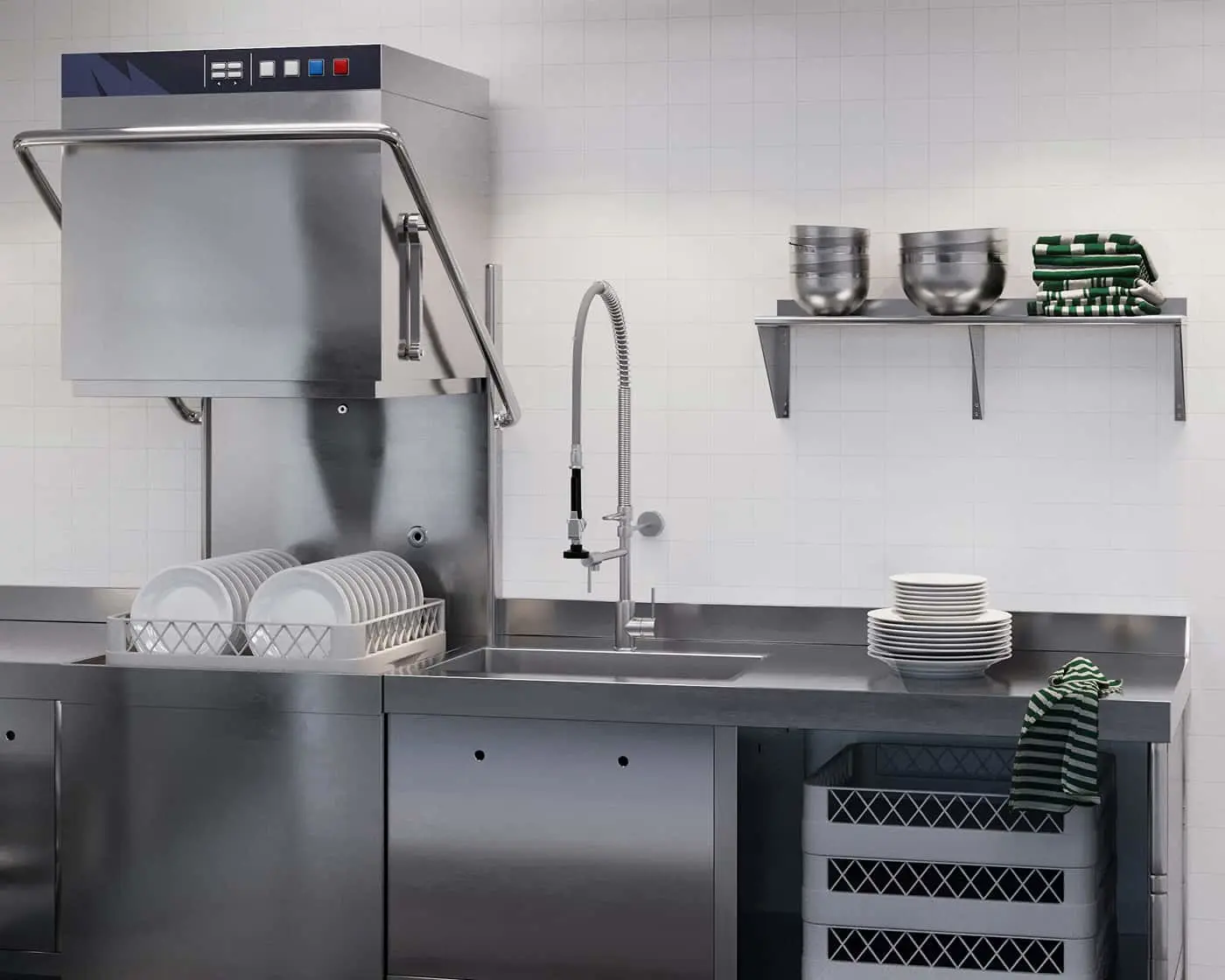 Commercial kitchen with stainless steel dishwasher, sink, and counter with stacked plates and bowls on shelves.
